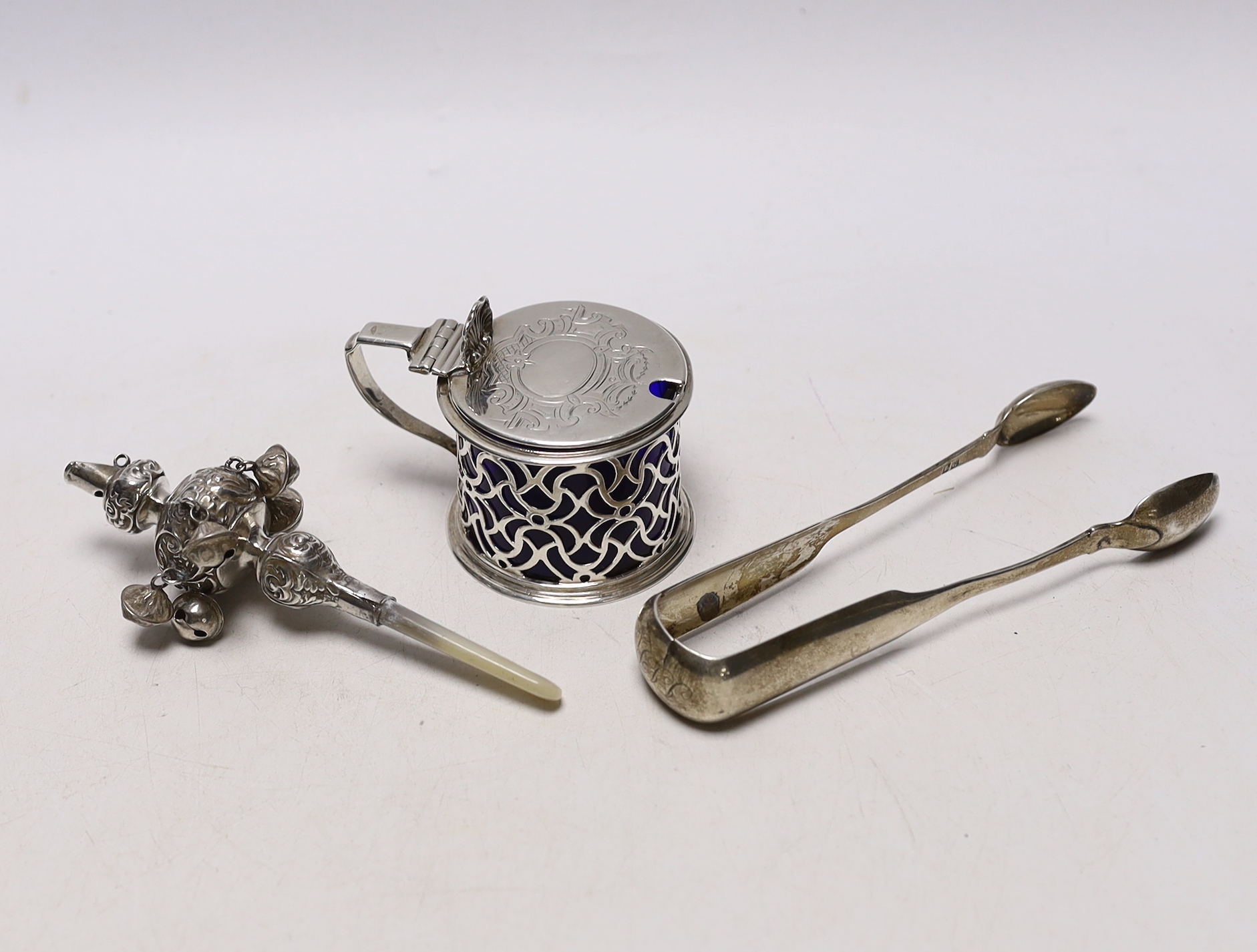 A Victorian pierced silver drum mustard pot, Charles & George Fox, London, 1854, a pair of 19th century Scottish provincial silver fiddle pattern sugar tongs, by David Gray of Dumfries, circa 1825 and a mother of pearl m